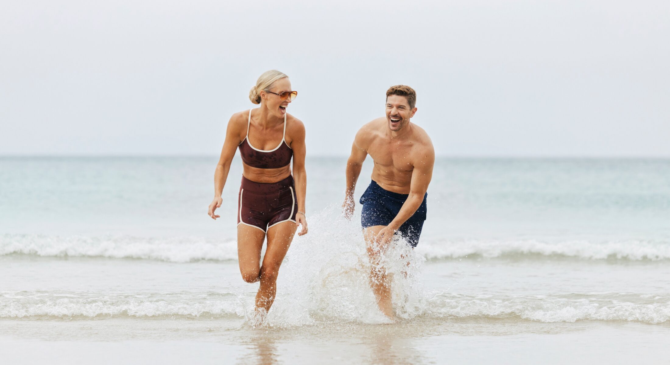 Couple playing in the waves at the beach